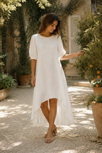 White linen high-low midi dress, front view, round neck, puff sleeves, high-low hem